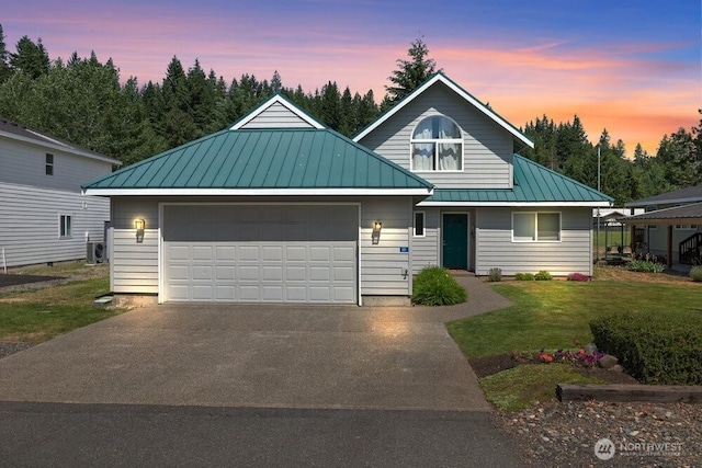 491 Pebble Beach Dr, Cle Elum, WA 98922 - view of front of home with a standing seam roof, a metal roof, a lawn, driveway, and a garage
