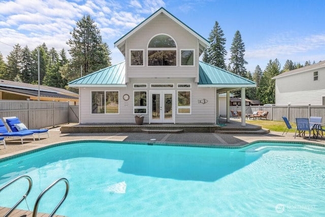 491 Pebble Beach Dr, Cle Elum, WA 98922 - rear view of property with a standing seam roof, french doors, a metal roof, and a fenced backyard
