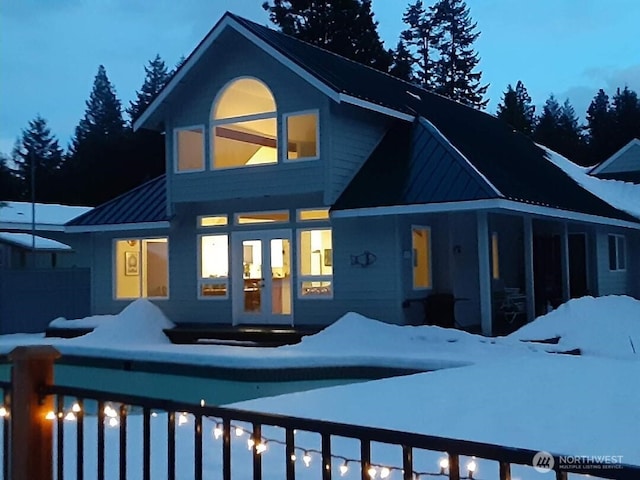 491 Pebble Beach Dr, Cle Elum, WA 98922 - snow covered rear of property with french doors, a standing seam roof, and a metal roof