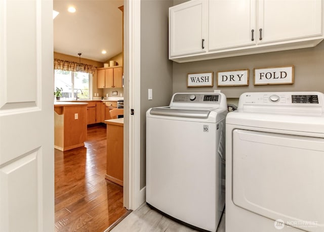 5117 77th St E, Tacoma, WA 98443 - laundry area featuring cabinet space, washer and clothes dryer, light wood-style flooring, and recessed lighting