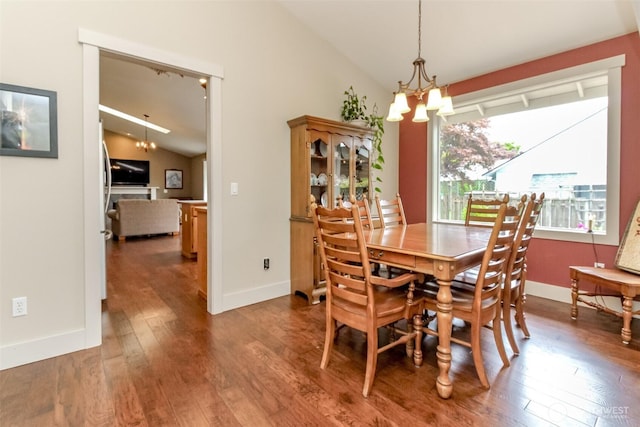 5117 77th St E, Tacoma, WA 98443 - dining room featuring vaulted ceiling, a chandelier, and wood-type flooring