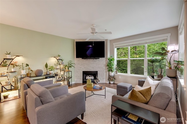 3116 164th St SW Unit 806, Lynnwood, WA 98087 - living room with wood finished floors, ceiling fan, and a stone fireplace
