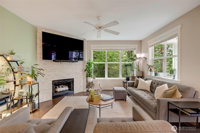 3116 164th St SW Unit 806, Lynnwood, WA 98087 - living room featuring wood finished floors, a ceiling fan, and a fireplace
