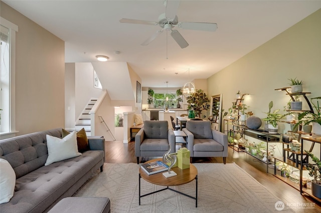3116 164th St SW Unit 806, Lynnwood, WA 98087 - living area with wood finished floors, stairs, a chandelier, and ceiling fan