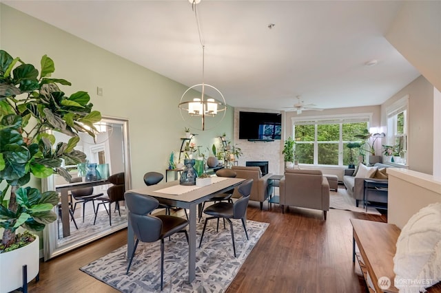 3116 164th St SW Unit 806, Lynnwood, WA 98087 - dining room with a fireplace, ceiling fan, dark wood-style floors, and a chandelier