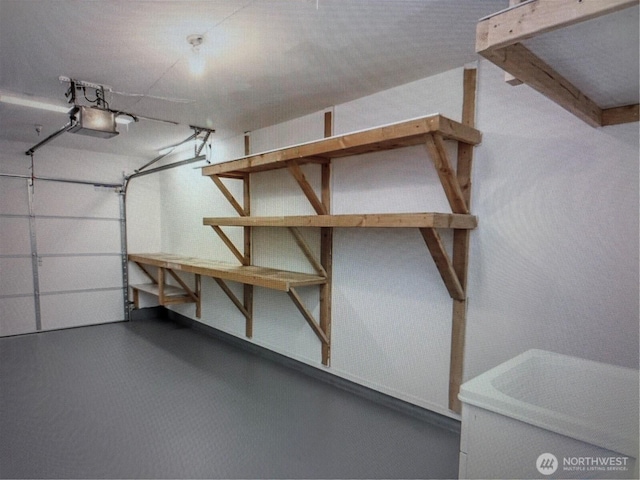 3116 164th St SW Unit 806, Lynnwood, WA 98087 - garage featuring a garage door opener and baseboards