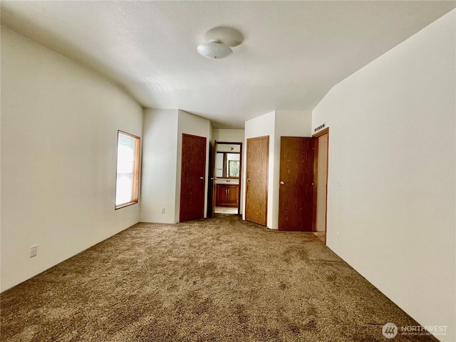 115 4th Ave SE, Soap Lake, WA 98851 - unfurnished bedroom featuring carpet and two closets