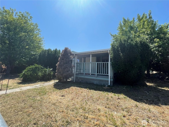 115 4th Ave SE, Soap Lake, WA 98851 - view of property exterior with a yard and covered porch
