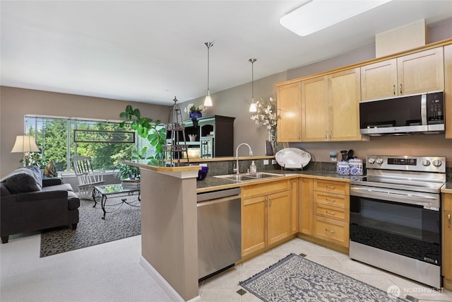 15000 Juanita Dr NE Unit 309, Kenmore, WA 98028 - kitchen with stainless steel appliances, a peninsula, light brown cabinetry, and decorative light fixtures