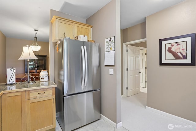 15000 Juanita Dr NE Unit 309, Kenmore, WA 98028 - kitchen featuring freestanding refrigerator, light brown cabinets, tile counters, hanging light fixtures, and light tile patterned floors