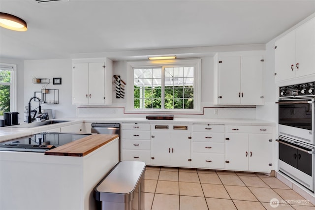 804 Electron Way, Fircrest, WA 98466 - kitchen featuring tasteful backsplash, light tile patterned floors, white cabinetry, stainless steel dishwasher, and white double oven