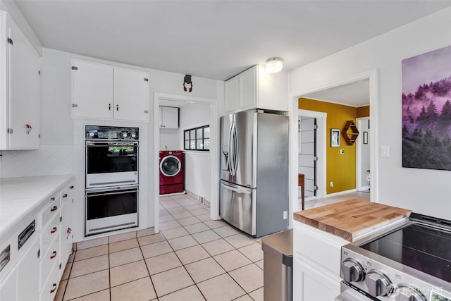 804 Electron Way, Fircrest, WA 98466 - kitchen featuring stainless steel fridge with ice dispenser, white double oven, stove, washer / dryer, and white cabinetry
