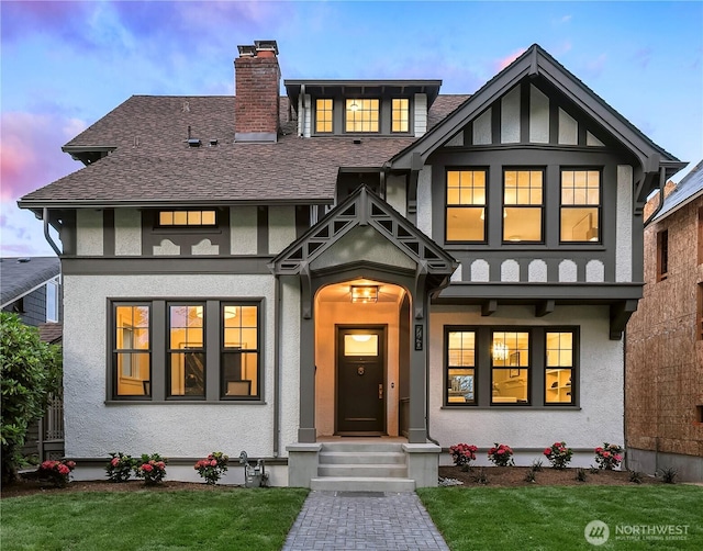 740 22nd Ave E, Seattle, WA 98112 - view of front of home featuring stucco siding, a front yard, and a shingled roof