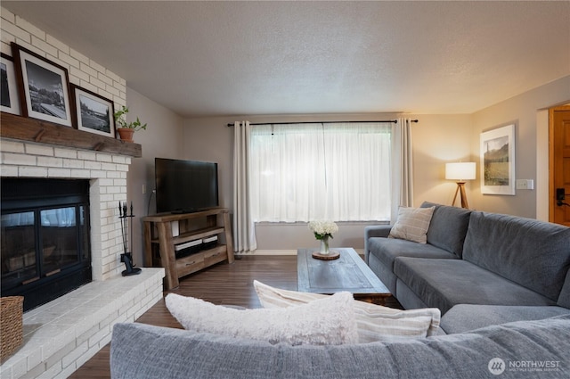 16420 92nd Avenue Ct E, Puyallup, WA 98375 - living room featuring a fireplace, dark wood finished floors, and a textured ceiling
