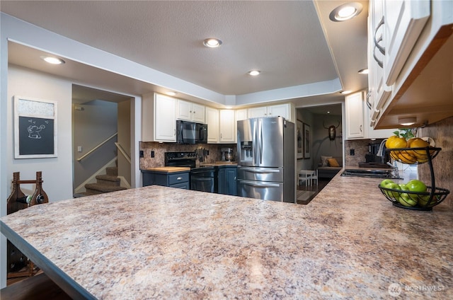 16420 92nd Avenue Ct E, Puyallup, WA 98375 - kitchen with black appliances, a peninsula, backsplash, light countertops, and recessed lighting