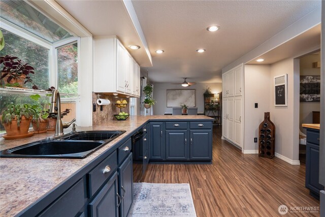16420 92nd Avenue Ct E, Puyallup, WA 98375 - kitchen with white cabinets, blue cabinets, light countertops, recessed lighting, and dark wood-style flooring