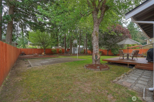 16420 92nd Avenue Ct E, Puyallup, WA 98375 - fenced backyard featuring a wooden deck and an outdoor structure