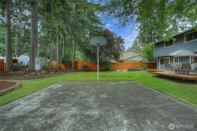 16420 92nd Avenue Ct E, Puyallup, WA 98375 - fenced backyard featuring a wooden deck, outdoor dining space, and a shed