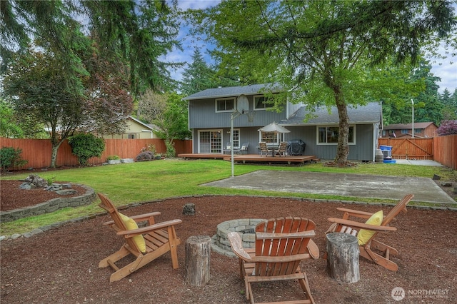 16420 92nd Avenue Ct E, Puyallup, WA 98375 - back of house featuring a fire pit, a fenced backyard, a wooden deck, a shingled roof, and a patio
