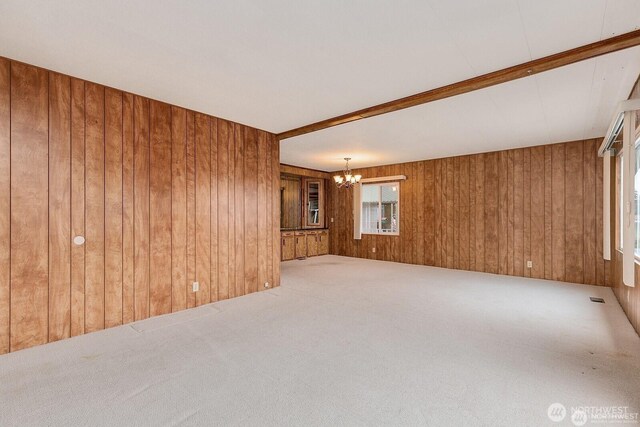 1415 84th St SE Unit 192, Everett, WA 98208 - spare room with a chandelier, wood walls, and carpet flooring