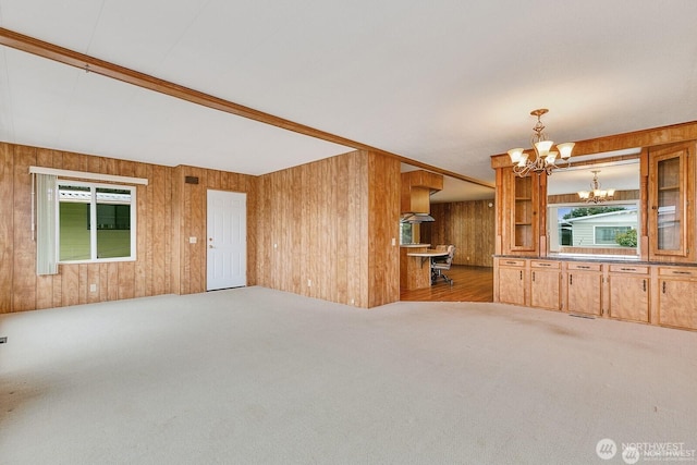 1415 84th St SE Unit 192, Everett, WA 98208 - unfurnished living room with a chandelier, wooden walls, and carpet flooring