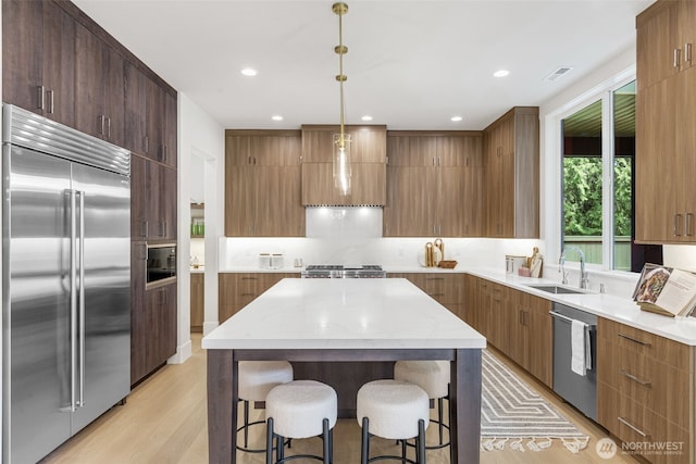 1806 154th Ave SE, Bellevue, WA 98007 - kitchen with stainless steel appliances, modern cabinets, light wood finished floors, light countertops, and recessed lighting