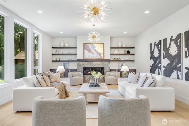1806 154th Ave SE, Bellevue, WA 98007 - living area featuring light wood finished floors, a fireplace, a chandelier, recessed lighting, and built in features