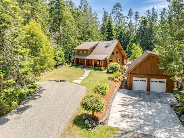 194 Protection Ridge Dr, Port Townsend, WA 98368 - log home featuring log siding, a front lawn, a wooded view, a detached garage, and a metal roof
