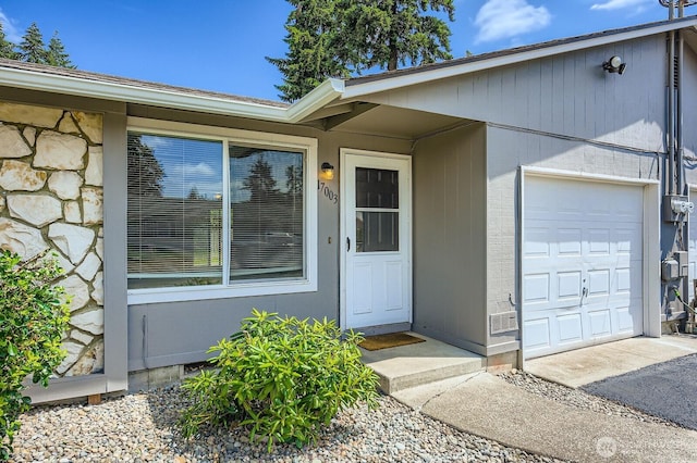 1700317009 16th Ave E, Spanaway, WA 98387 - doorway to property featuring an attached garage and stone siding