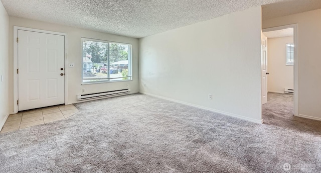 1700317009 16th Ave E, Spanaway, WA 98387 - carpeted spare room featuring baseboard heating, plenty of natural light, a textured ceiling, and tile patterned flooring