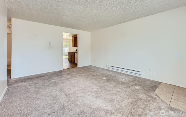 1700317009 16th Ave E, Spanaway, WA 98387 - carpeted empty room featuring baseboard heating and a textured ceiling