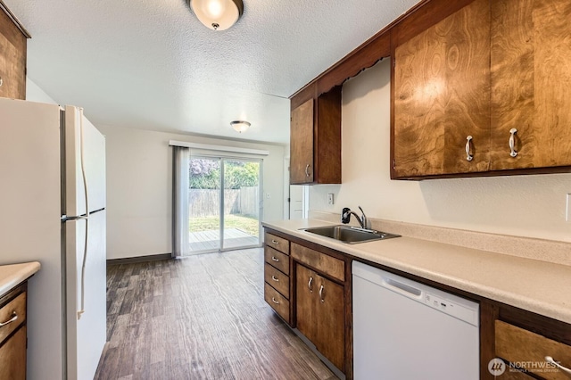 1700317009 16th Ave E, Spanaway, WA 98387 - kitchen with white appliances, dark wood finished floors, light countertops, and a textured ceiling