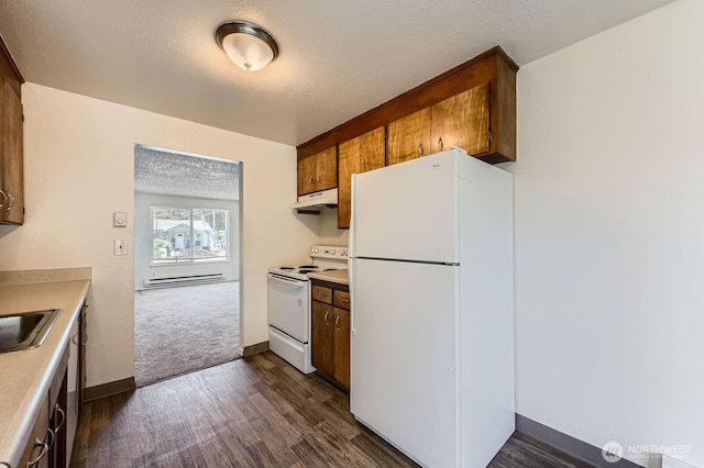 1700317009 16th Ave E, Spanaway, WA 98387 - kitchen featuring white appliances, under cabinet range hood, light countertops, dark wood-style flooring, and a textured ceiling