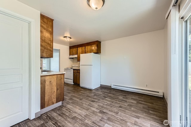 1700317009 16th Ave E, Spanaway, WA 98387 - kitchen featuring a baseboard radiator, white appliances, dark wood-type flooring, under cabinet range hood, and brown cabinets