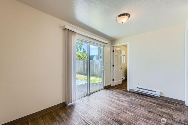 1700317009 16th Ave E, Spanaway, WA 98387 - empty room with baseboard heating and dark wood finished floors