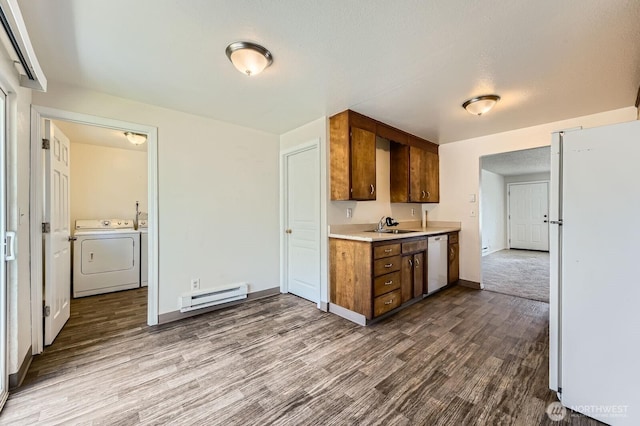 1700317009 16th Ave E, Spanaway, WA 98387 - kitchen featuring baseboard heating, white appliances, separate washer and dryer, dark wood finished floors, and light countertops