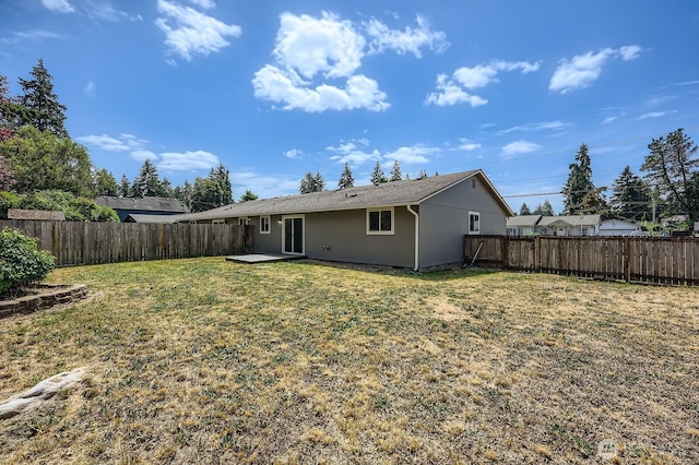 1700317009 16th Ave E, Spanaway, WA 98387 - rear view of house with a fenced backyard and a patio area