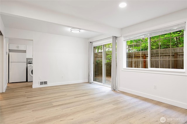12211 SE 59th St Unit 61, Bellevue, WA 98006 - spare room with washer / clothes dryer, light wood-style floors, and recessed lighting