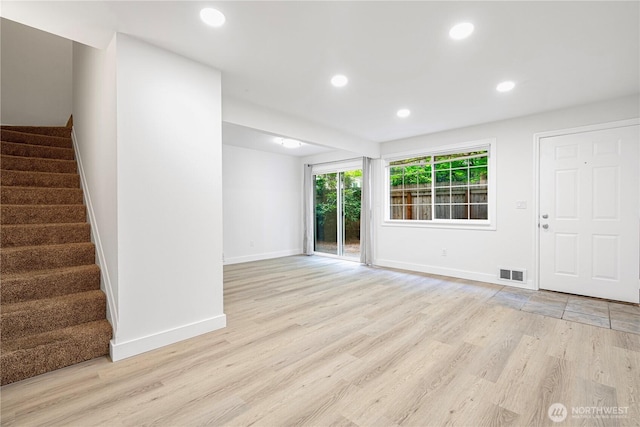 12211 SE 59th St Unit 61, Bellevue, WA 98006 - unfurnished living room featuring light wood-type flooring, stairs, and recessed lighting