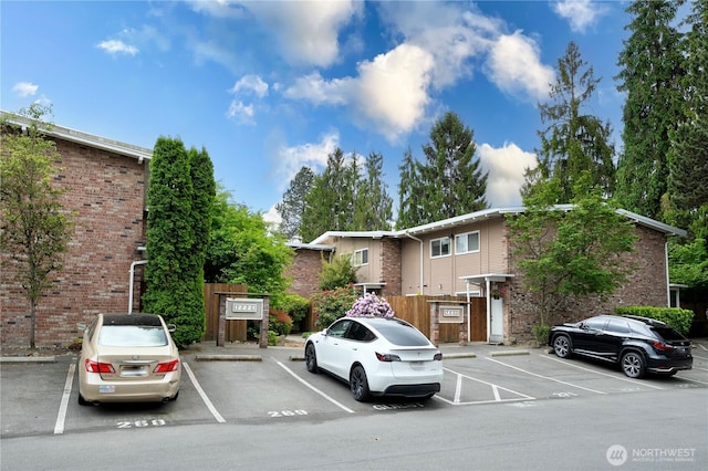 12211 SE 59th St Unit 61, Bellevue, WA 98006 - view of front of house with uncovered parking and brick siding