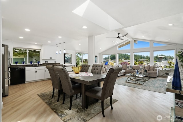 153 Swinomish Dr, La Conner, WA 98257 - dining space with healthy amount of natural light, light wood finished floors, ceiling fan, vaulted ceiling, and a skylight