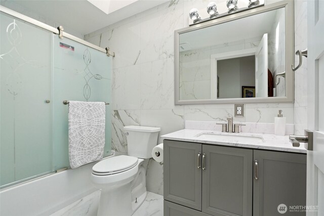 153 Swinomish Dr, La Conner, WA 98257 - bathroom featuring tile walls, vanity, shower / bath combination with glass door, and marble finish floors