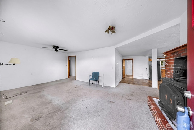 8739 F And S Grade Rd, Sedro Woolley, WA 98284 - carpeted living area with a wood stove and ceiling fan