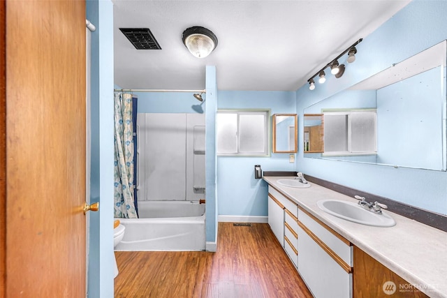 8739 F And S Grade Rd, Sedro Woolley, WA 98284 - bathroom featuring double vanity, wood finished floors, and shower / bathtub combination with curtain