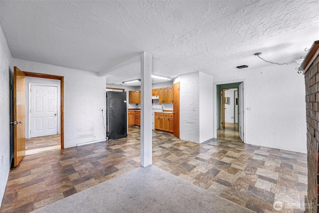 8739 F And S Grade Rd, Sedro Woolley, WA 98284 - unfurnished living room with a textured ceiling and stone finish flooring