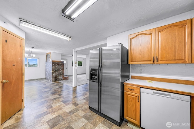 8739 F And S Grade Rd, Sedro Woolley, WA 98284 - kitchen with stainless steel refrigerator with ice dispenser, dishwasher, light countertops, a textured ceiling, and stone finish floors