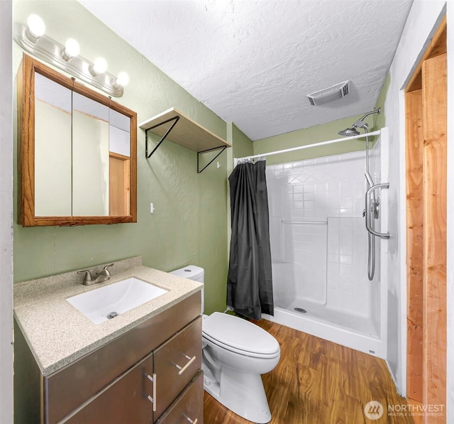 8739 F And S Grade Rd, Sedro Woolley, WA 98284 - full bathroom with wood finished floors, vanity, a shower with curtain, and a textured ceiling