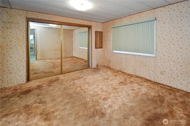 8031 Fir Tree Ln, Lake Stevens, WA 98258 - unfurnished bedroom featuring wallpapered walls, carpet floors, and a closet