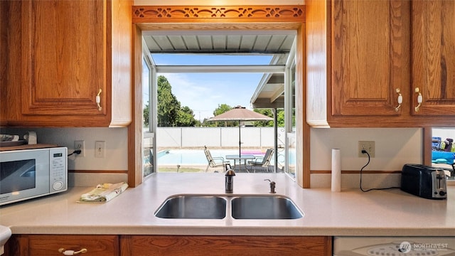 1314 S Division St, Walla Walla, WA 99362 - kitchen featuring white microwave, brown cabinetry, light countertops, and dishwashing machine