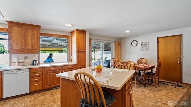 1314 S Division St, Walla Walla, WA 99362 - kitchen with white dishwasher, light countertops, healthy amount of natural light, brown cabinets, and recessed lighting